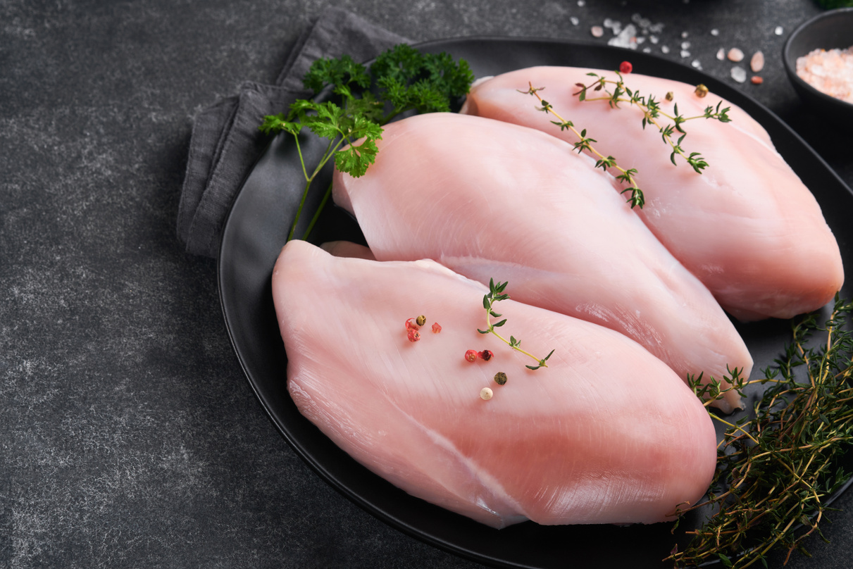 Chicken breast. Raw chicken breast fillets on black ceramic
